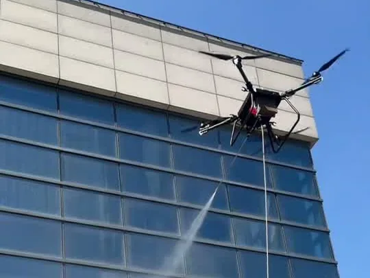 Drone shown in a building-facade cleaning context